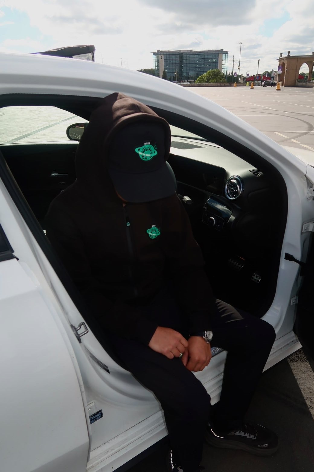 MUND hoodie and cap look beside a white car